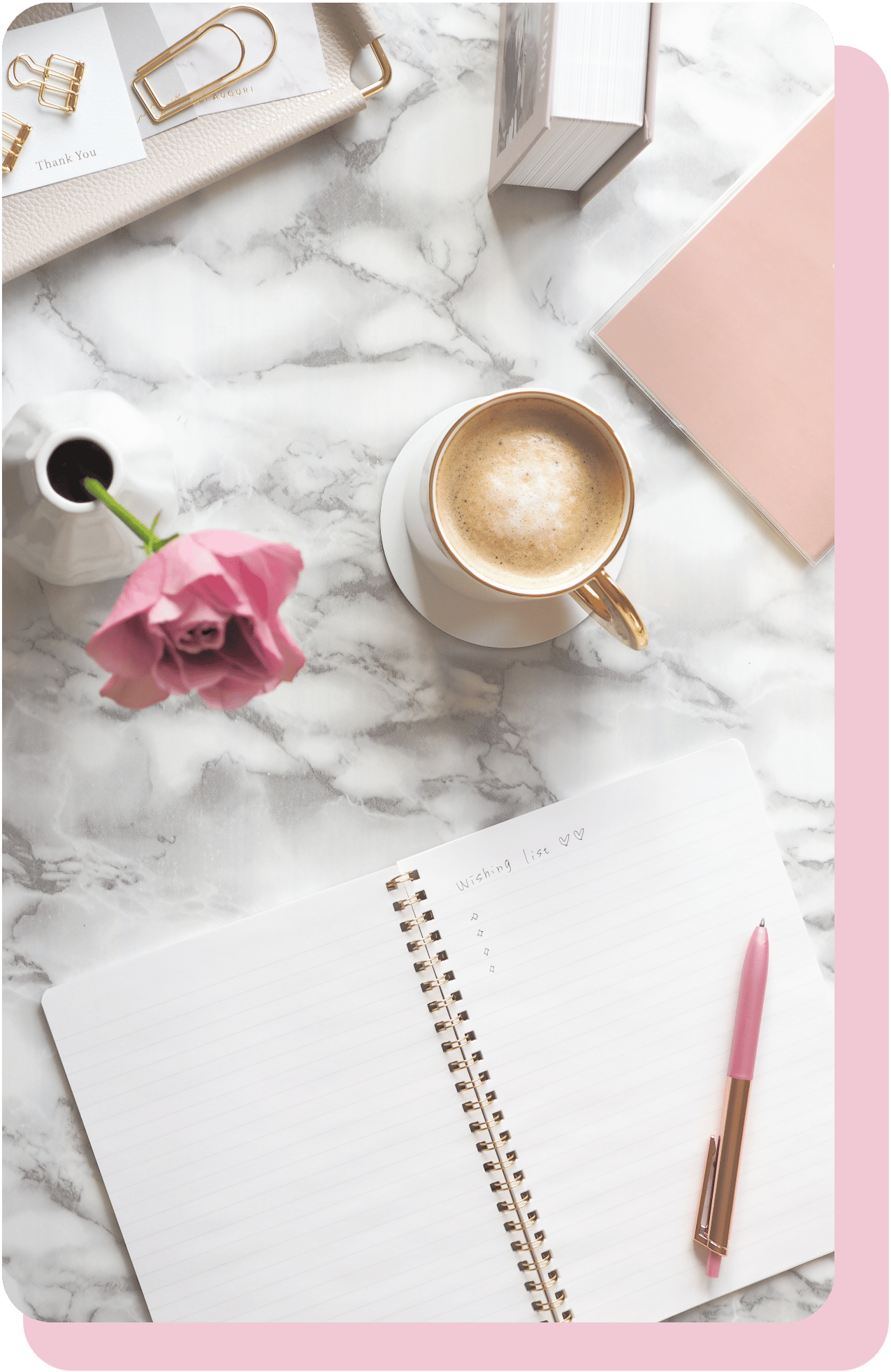 Aesthetic arrangement of a notebook, pen, vase with a flower, coffee cup, and office supplies on a marble table, representing organized support for therapists.