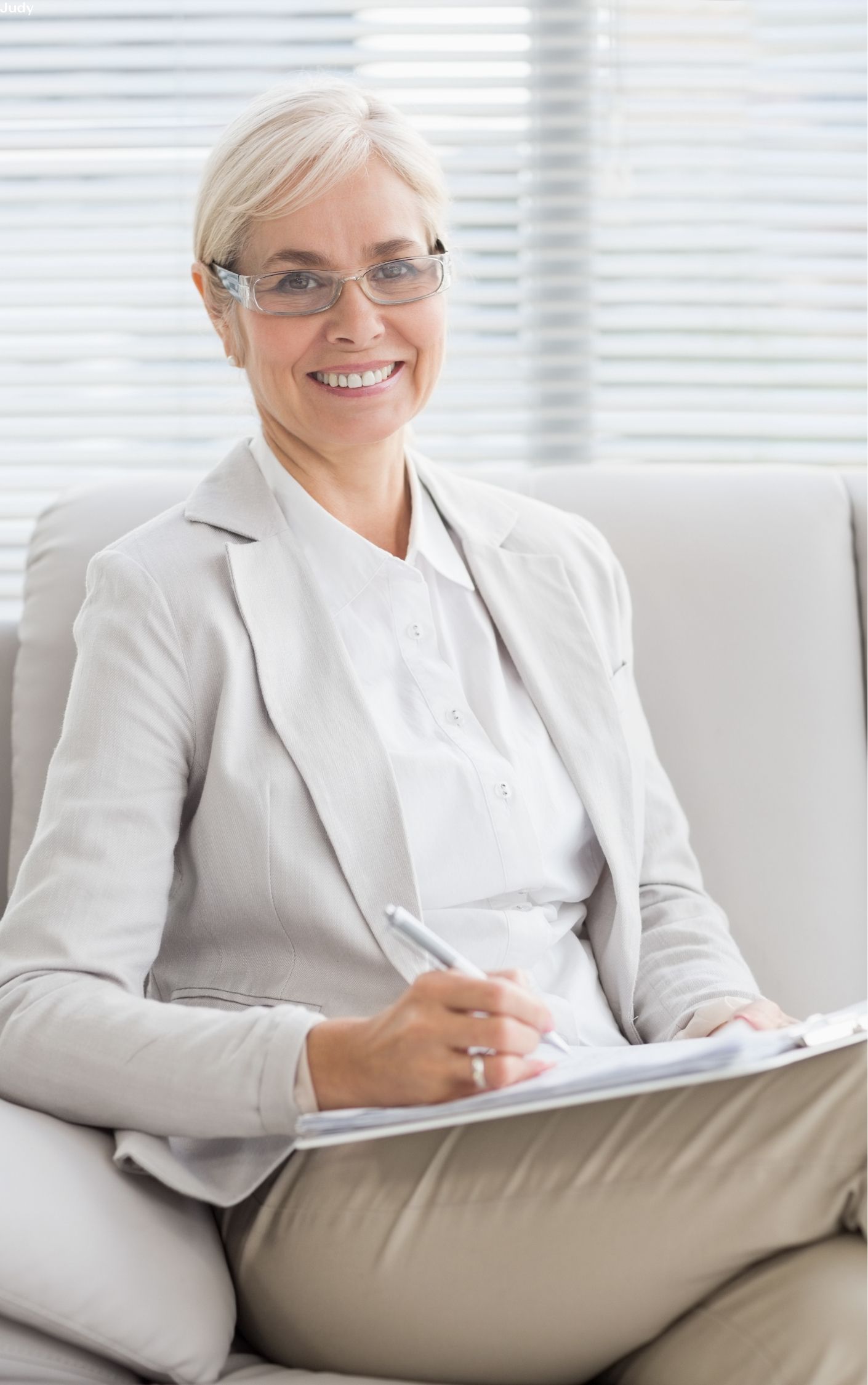 A smiling counselor sitting in her office