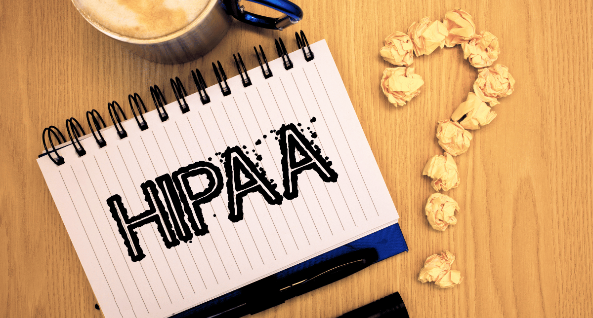 Notebook with 'HIPAA' written on a page and a question mark next to it